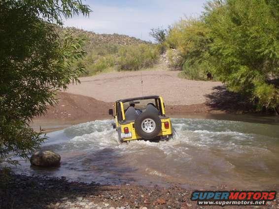 ericwater.jpg we found a nice water crossing out there, here is eric crossing it. lets just say he got a little wet with no doors