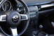 2006 Mazda Miata - Interior view of a 2006 Mazda Miata, highlighting the steering wheel, dashboard, and center console.