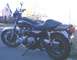 1977 Kawasaki KZ1000-A1 - A black 1977 Kawasaki KZ1000-A1 motorcycle is parked on a street with a house in the background.