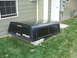 1992 Ford Ranger - A black Trail-Master truck bed cap is shown outdoors next to a building.