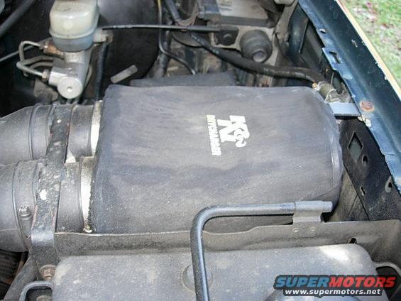 K&N air filter assembly in engine bay, with brake fluid reservoir visible