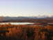 1982 Chevrolet C/K Pickup - Expansive landscape mountains, a lake, and fall foliage under a clear sky.