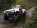 1990 Ford Bronco - This heavily modified Toyota pickup truck navigates a challenging off-road course with large tires and a lifted suspension.