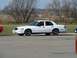 1997 Mercury Grand Marquis - A white 1997 Mercury Grand Marquis is seen from the side at an outdoor meet.