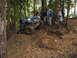 1990 Ford Bronco - Modified off-road vehicle navigates a challenging muddy incline with spectators observing.