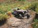 1990 Ford Bronco - A customized Toyota Land Cruiser FJ40 navigates a challenging off-road course with a roll cage and custom seats.