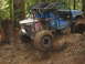 1990 Ford Bronco - This heavily modified off-road vehicle is shown on a challenging muddy course.