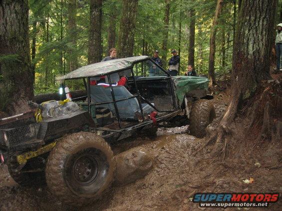 Modified off-road vehicle with large tires stuck in mud