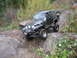 1990 Ford Bronco - Off-roading in a modified Jeep Wrangler on a challenging rocky path.