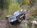 1990 Ford Bronco - Ford Bronco tackling a challenging off-road course with onlookers present.