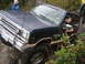 1990 Ford Bronco - 1990 Ford Bronco tackling a rocky trail with a driver behind the wheel.