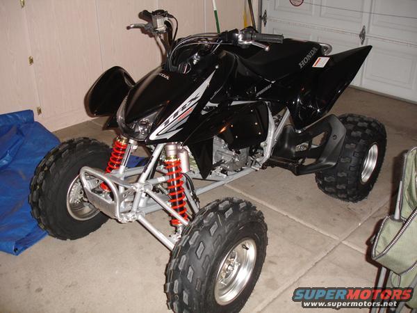 Black 2005 Honda TRX 450 R ATV with red shocks, three-quarter front view