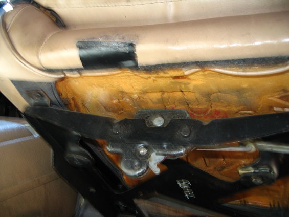 close-up of a vehicle seat's metal frame and exposed foam padding