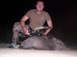 2005 BMW 3 Series - A hunter poses with his javelina kill at night.