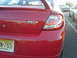 2005 Dodge SRT-4 - Rear view of a red 2005 Dodge SRT-4 with a New Jersey license plate, parked in a lot.