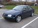 2002 Volkswagen Jetta - A dark blue 2002 Volkswagen Jetta sedan is parked in a lot on a cloudy day.