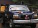 1995 Ford F-250 - This Ford F-250 pickup truck is equipped with a ladder rack and additional lights on the front.