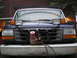 1995 Ford F-250 - Blue Ford F-Series truck front end with plow mount and extra lights installed.