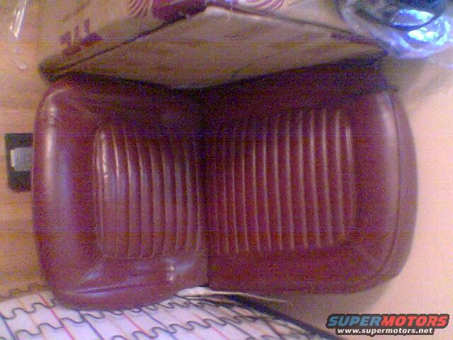 Red vinyl seat cushion with vertical pleats