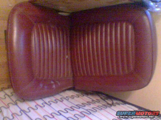 Maroon vinyl car seat cushion with vertical pleats