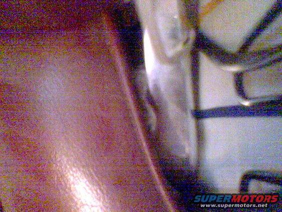 Close-up of vehicle interior wiring harness and metal panel