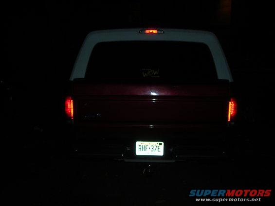 1995 Ford Bronco rear view, showing taillights, license plate RHF 37E, and a sticker on the rear window
