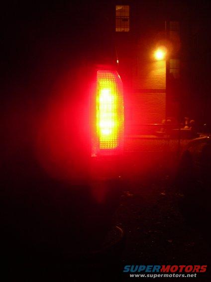 Red tail light on a 1995 Ford Bronco, illuminated with yellow LEDs