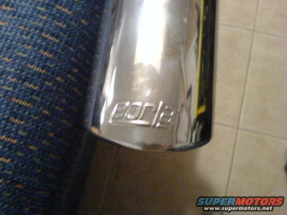Chrome exhaust tip with 'Borla' logo embossed on it