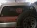 1989 Ford Bronco - A close-up view of a vehicle's rear window, a fire department emblem and a spare tire mounted nearby.