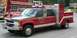 1989 Ford Bronco - A red and black crew cab truck with a service body, marked "Squad 70" and "VOL. FIRE CO. NO. 1 GRILL, PA", is parked near other fire vehicl…