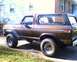 1979 Ford Bronco - This classic Ford Bronco is parked on a driveway next to a residential building.