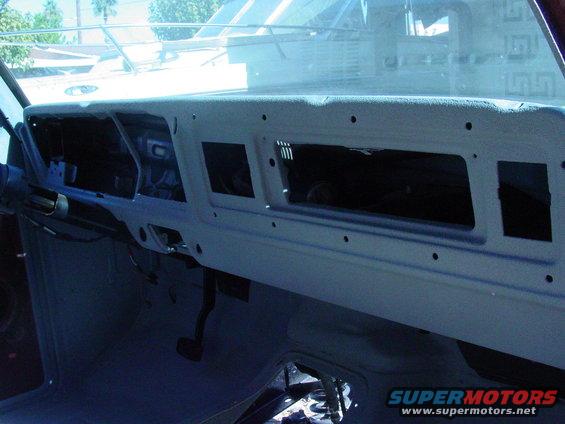 Gray dashboard interior with empty instrument panel and vents