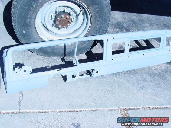 1978 Ford Bronco grille surround, light blue primer, with tire and wheel in background