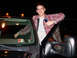 1970 Mercury Cougar - A man poses next to a truck at night, with the driver's side door open.