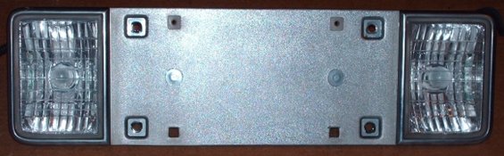 License plate bracket with two rectangular headlights, silver metal center, dark gray trim