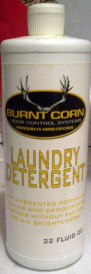 Bottle of Burnt Corn Laundry Detergent with deer antlers logo