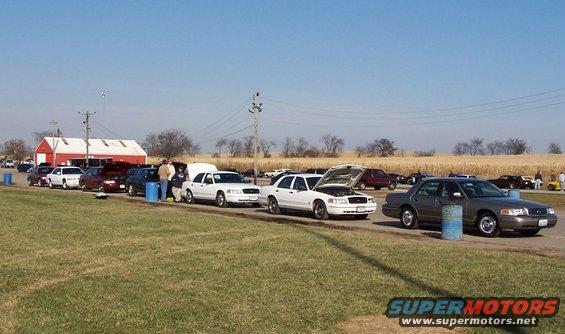 Gray 2000 Ford Crown Victoria parked on a road with other cars