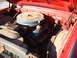 1961 Ford Starliner - Close-up view of a red vehicle's engine bay, a blue air cleaner and V8 engine components.