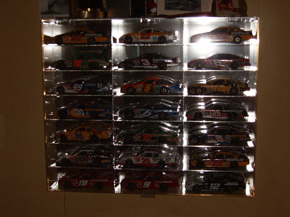Display case with 18 NASCAR diecast cars, each in its own compartment