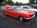 2002 Ford Mustang - Classic red Ford Mustang coupe with hood open, parked beside a white convertible.