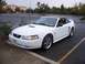 2002 Ford Mustang - White 2002 Ford Mustang convertible with the top down, parked in a lot.