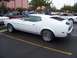 2002 Ford Mustang - A white 1971 Ford Mustang coupe is parked in a lot, with other vehicles visible in the background.