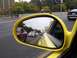2002 Ford Mustang - View of traffic from inside a yellow car, seen through the side mirror.