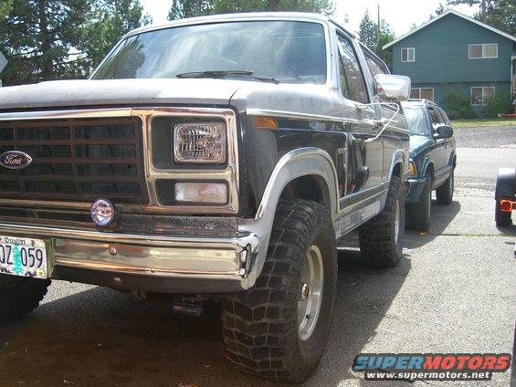 1982 Ford Bronco parked next to another SUV, front quarter view