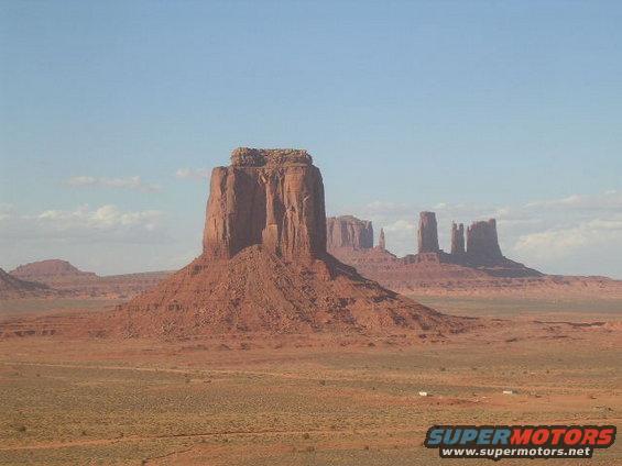Monument Valley landscape with mesas and buttes under a blue sky
