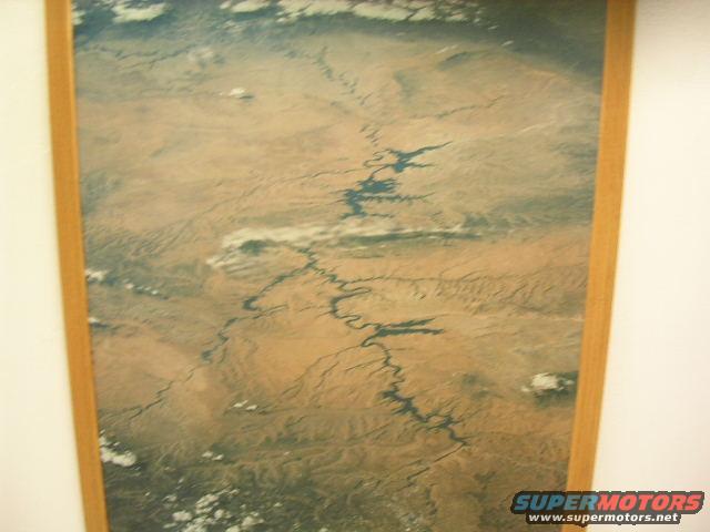 aerial view of a winding river through a desert landscape with clouds