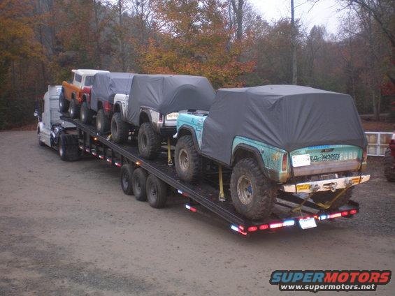 Rear view of a teal 1969 Ford Bronco on a trailer, with "OLD HORSE" text visible