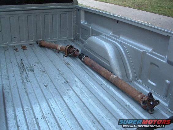 Driveshaft lying in the bed of a pickup truck