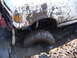 1989 Ford Bronco - A white 1989 Ford Bronco is deeply stuck in mud, with its front wheel submerged.