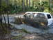 1989 Ford Bronco - Muddy 1989 Ford Bronco navigating a difficult off-road path.